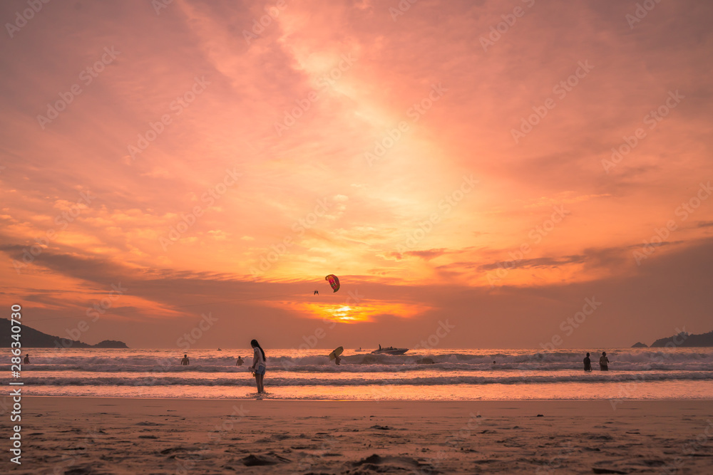 Sunset lovers, bright orange sky, on the beach Famous Phuket Patong Thailand