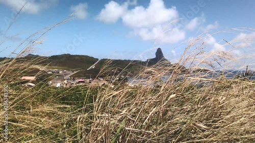 Fernando de Noronha Island, Pernambuco, Brazil - July, 2019 - Beautiful 4k footage near Saint Pedro Chapel with the view of Pico Hill and Porto de Santo Antonio beach.