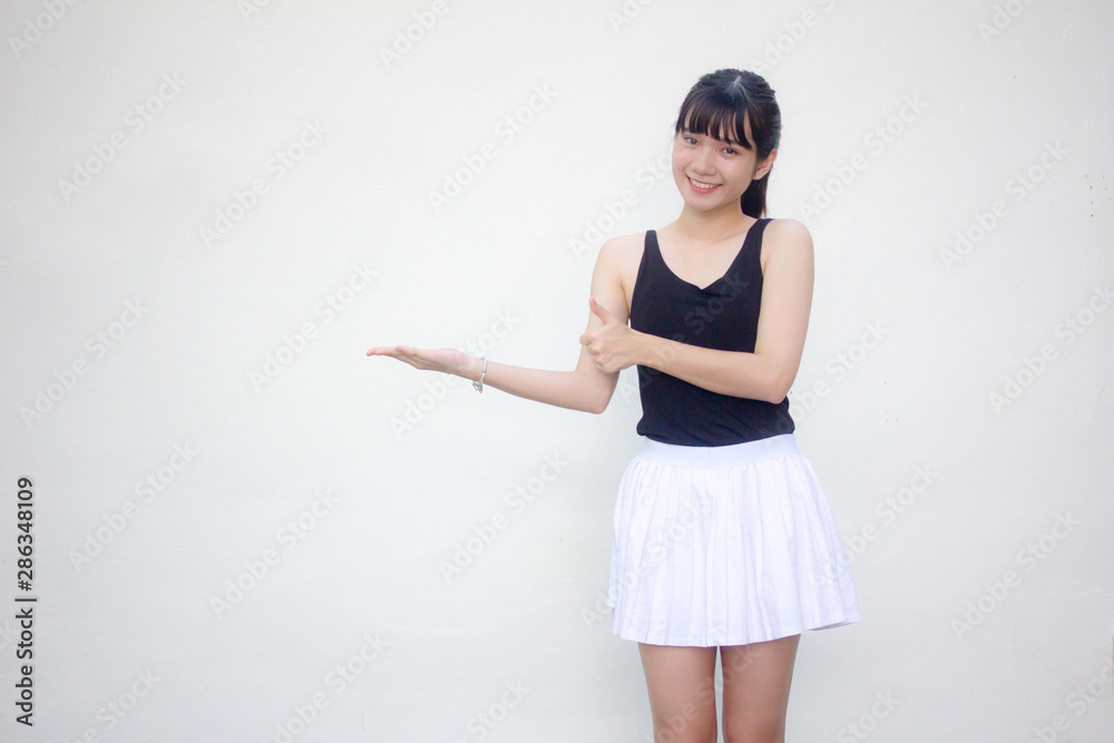 Portrait of thai adult beautiful girl black shirt white skirt show hand Portrait of thai adult beautiful girl black shirt white skirt show hand