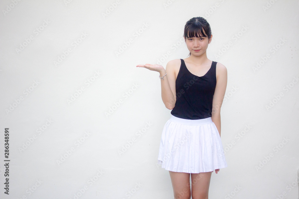 Portrait of thai adult beautiful girl black shirt white skirt show hand Portrait of thai adult beautiful girl black shirt white skirt show hand