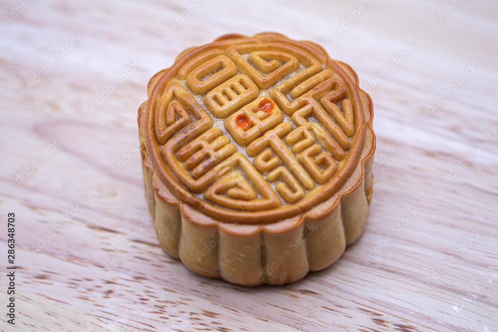Close up of Chinese moon cake on wooden plate background.Mid autumn festival. Close up of Chinese moon cake on wooden plate background.Mid autumn festival.