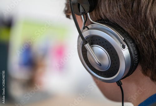 Boy listens to music on his on head phones