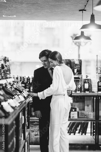 happy couple in the interior of a wine bar. bright emotions in a family photo shoot.