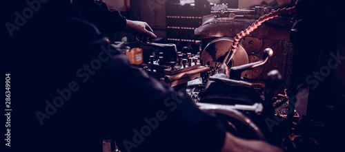 Industrial factory worker operate Lathe machine