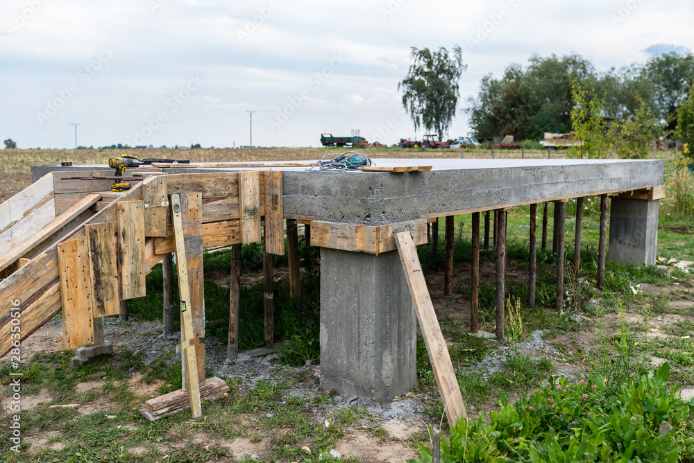 Reinforced concrete slab in the shape of a rectangle on concrete poles. Visible formwork and building punches. Reinforced concrete slab in the shape of a rectangle on concrete poles. Visible formwork and building punches.