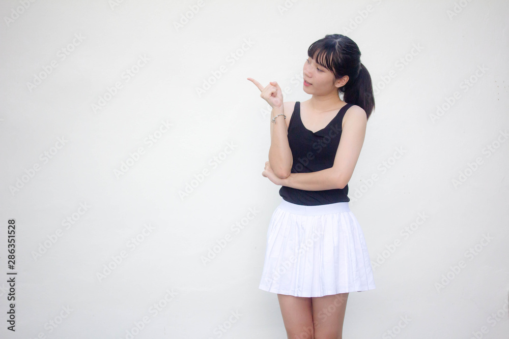 Portrait of thai adult beautiful girl black shirt white skirt pointing Portrait of thai adult beautiful girl black shirt white skirt pointing