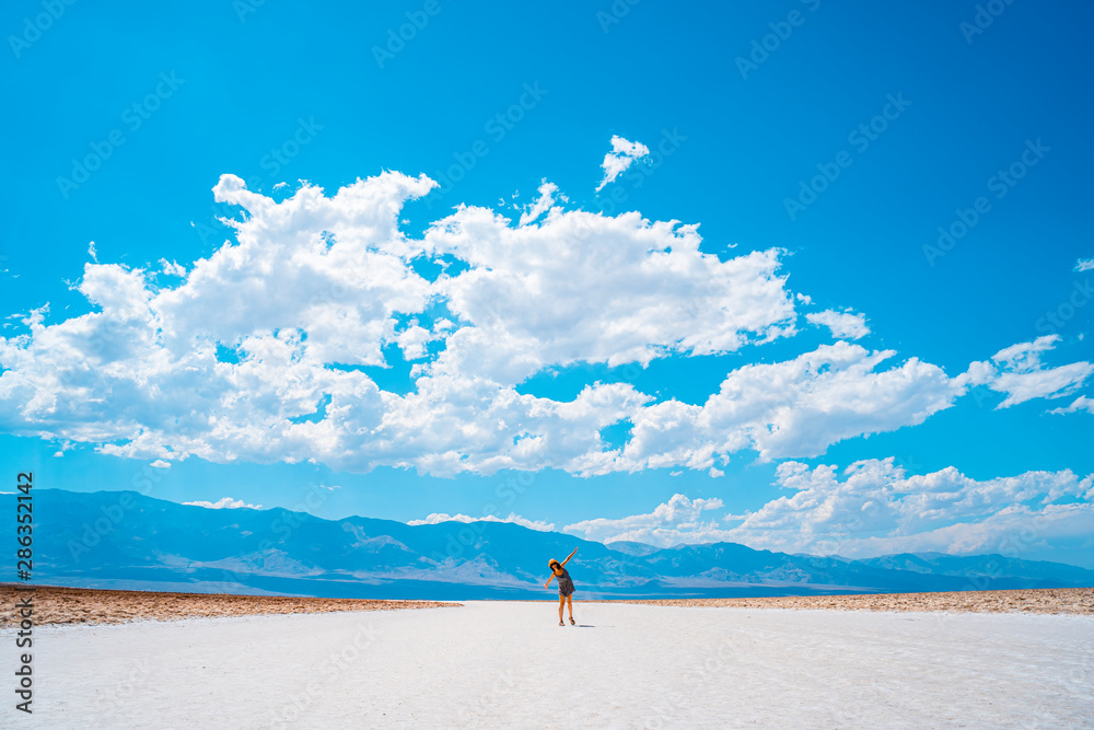 Death Valley, California / United States »; August 2019: A young woman in the white salt of Badwater Basin