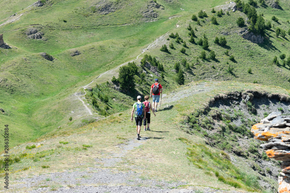 Group of hikers walking in mountains