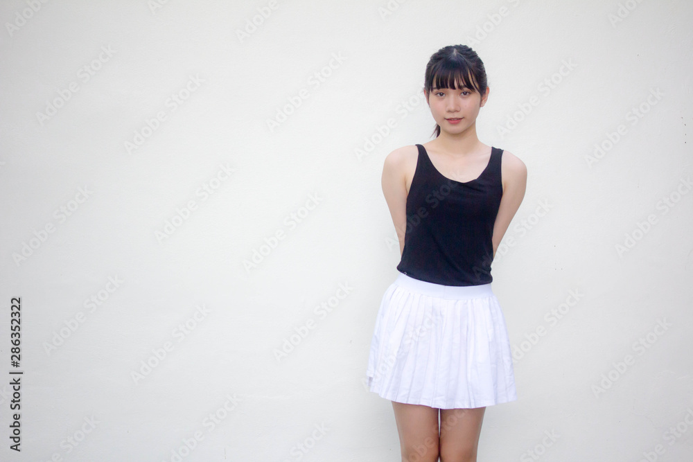 Portrait of thai adult beautiful girl black shirt white skirt relax and smile Portrait of thai adult beautiful girl black shirt white skirt relax and smile