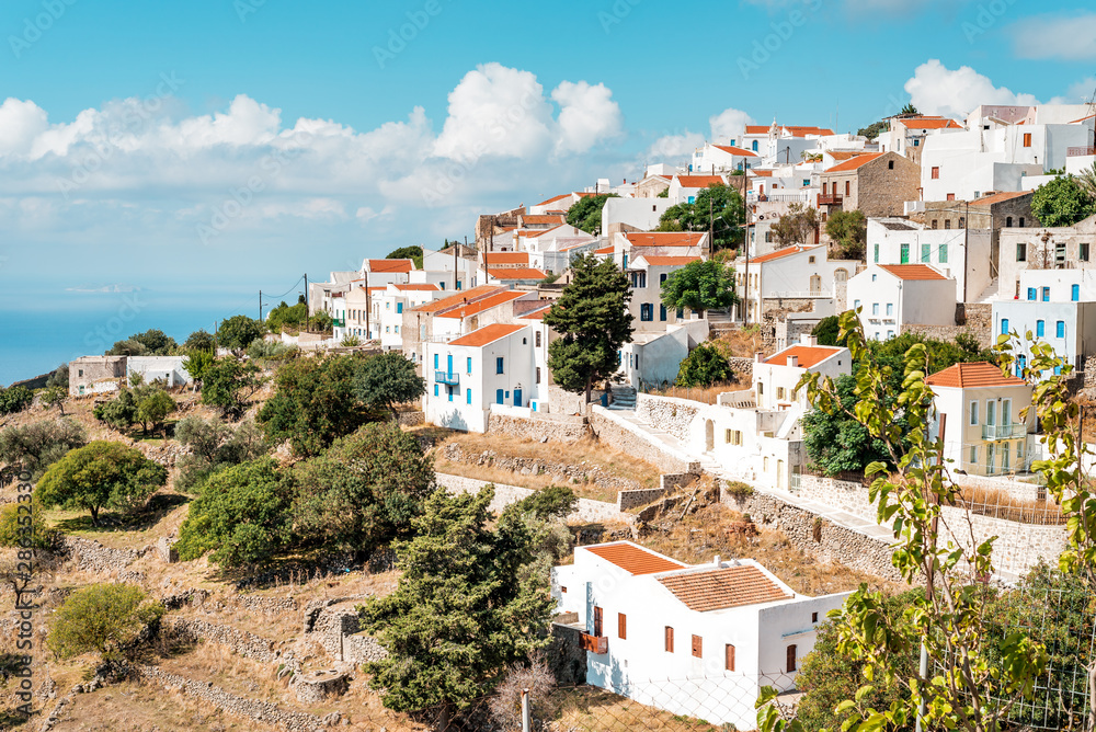 Typical Greek mountain village of Nikia with white houses and red roofs, Nisyros Island, Greece