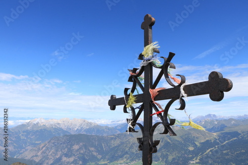 cross over a mountain against blue sky, cima cece, peak 