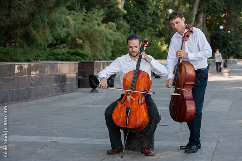 Classical music professional cello player solo performance, hands close up, unrecognizable person