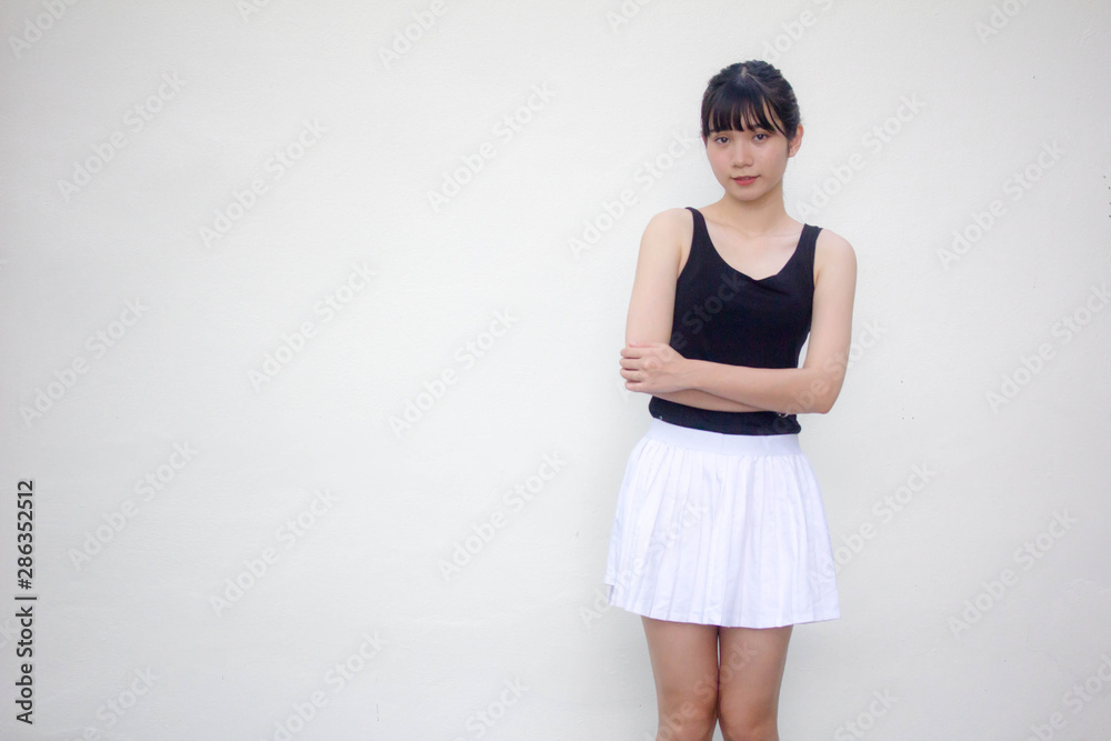 Portrait of thai adult beautiful girl black shirt white skirt relax and smile Portrait of thai adult beautiful girl black shirt white skirt relax and smile