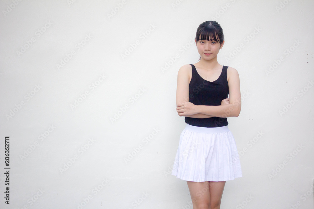 Portrait of thai adult beautiful girl black shirt white skirt relax and smile Portrait of thai adult beautiful girl black shirt white skirt relax and smile