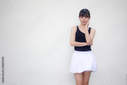 Portrait of thai adult beautiful girl black shirt white skirt relax and smile © tiniroma