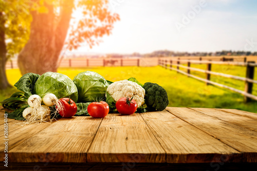 Table background with fresh vegetables and sunny autumn view. 