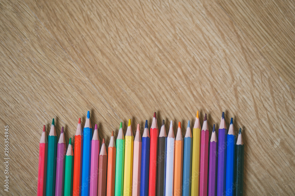 Color pencils on wooden background with copy space. Back to school and education concept. Color pencils on wooden background with copy space. Back to school and education concept.