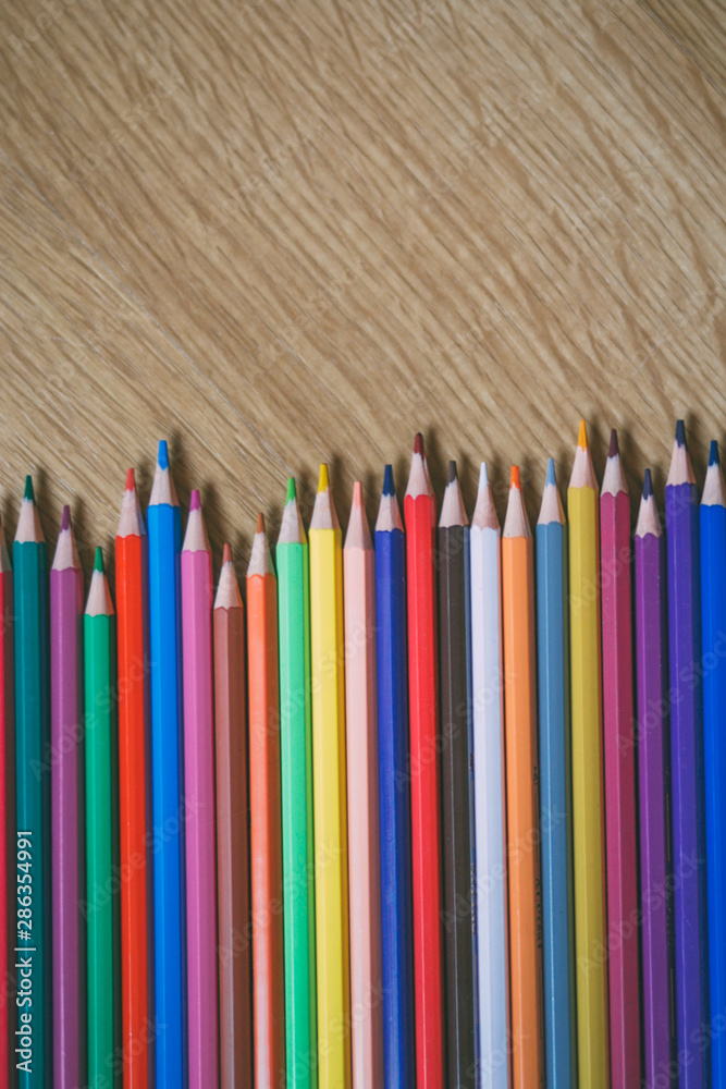 Color pencils on wooden background with copy space. Back to school and education concept. Color pencils on wooden background with copy space. Back to school and education concept.