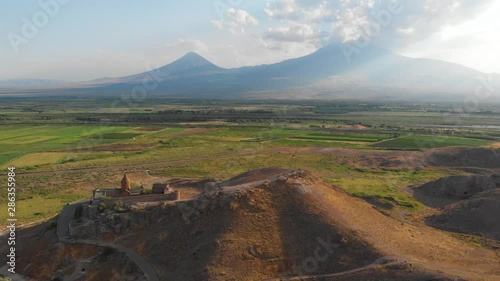 Khor Virap with Mount Ararat in background. The Khor Virap is an Armenian monastery located in the Ararat plain in Armenia, near the border with Turkey. Aerial flight video