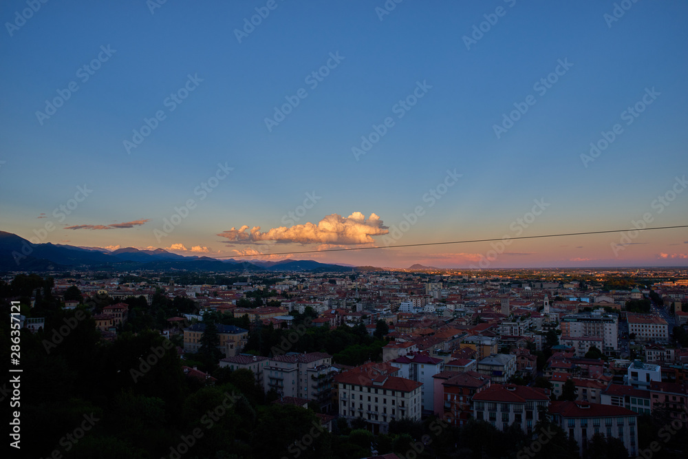 Bergamo with Alps mountains and blue cloudy sky