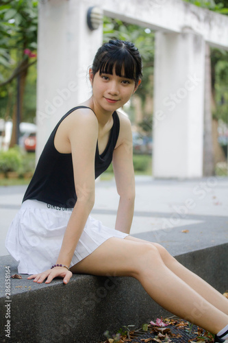 Portrait of thai adult beautiful girl black shirt white skirt relax time