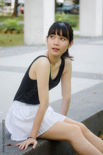 Portrait of thai adult beautiful girl black shirt white skirt relax time © tiniroma