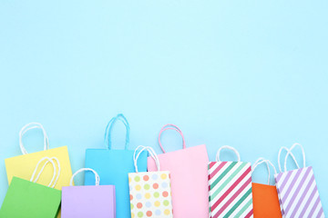 Small paper shopping bags on blue background
