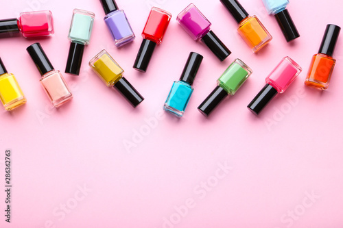 Nail polish bottles on pink background