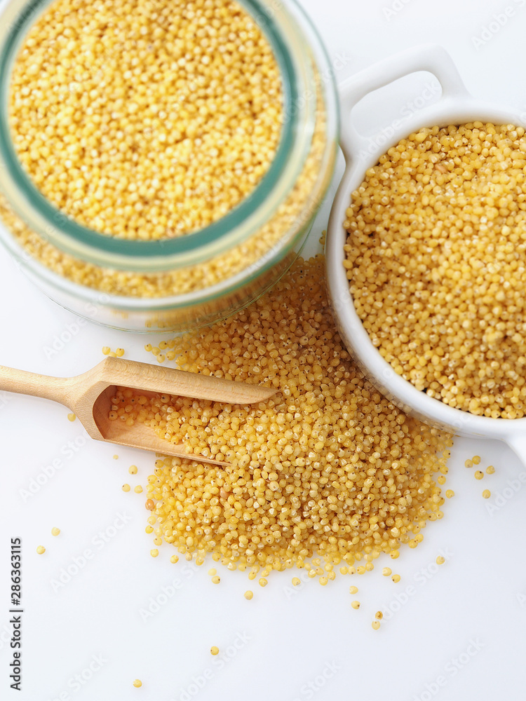 Dried raw millet on the white background Dried raw millet on the white background