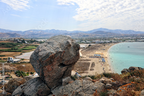 A boulder overlooking Agios Prokopios beach and turquoise sea, Naxos Greek Islands photo