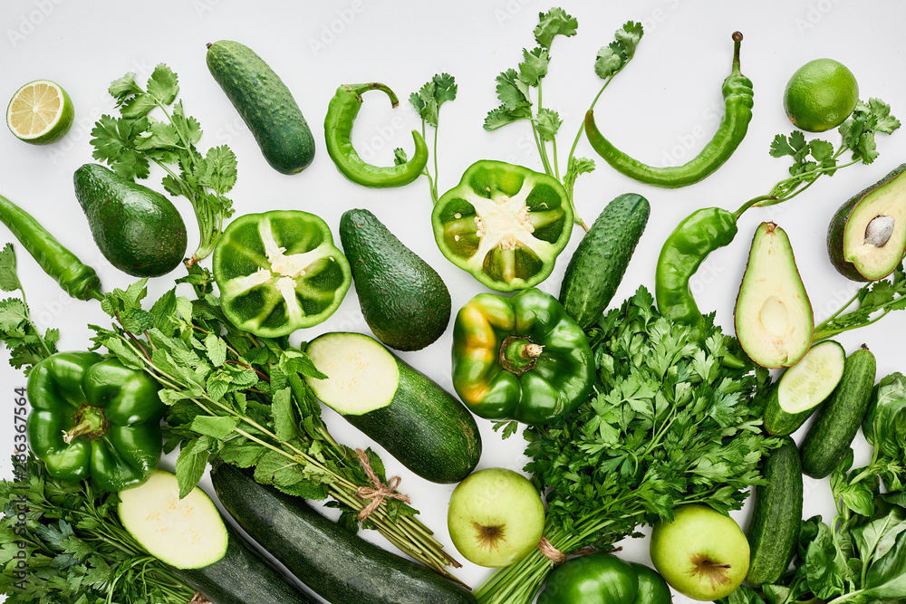 top view of apples, avocados, cucumbers, limes, peppers, greenery and zucchini top view of apples, avocados, cucumbers, limes, peppers, greenery and zucchini