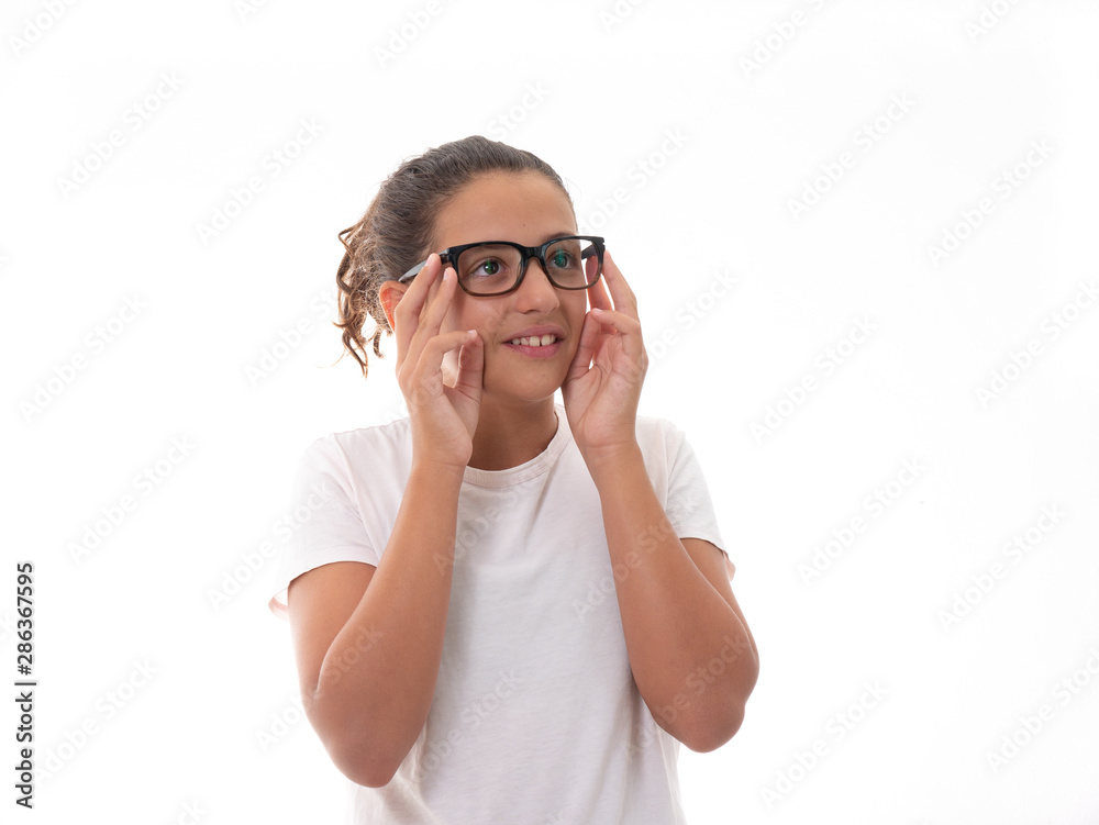 portrait of a young girl wearing glasses and doing funny faces isolated on white background