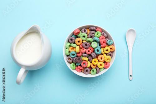 Valokuvatapetti Colorful corn rings with milk in jar and spoon on blue background