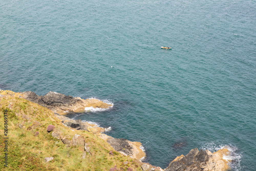 Two men and a dog in a small boat