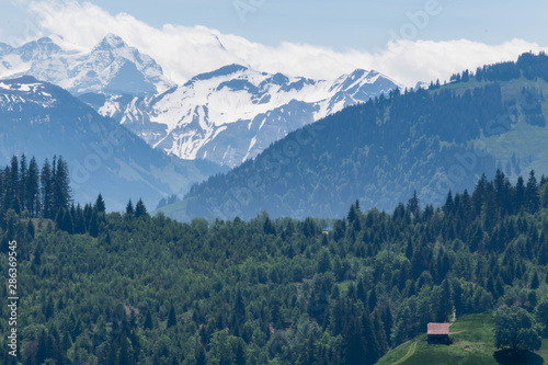 Scenic view on single house in the Alps mountains, Switzerland