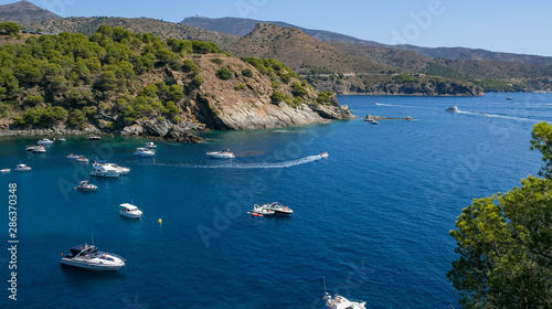 Paradisial bays, blue sea, purely water, moorages with boats and yachts on mountains and sky background. Amazing resort destination. Mediterranean resort in a wonderful bay on a sunny day.