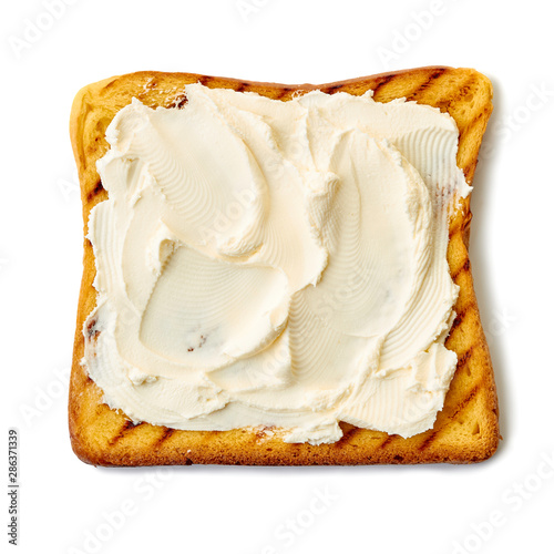 Roasted slice of toast bread with cream cheese on white