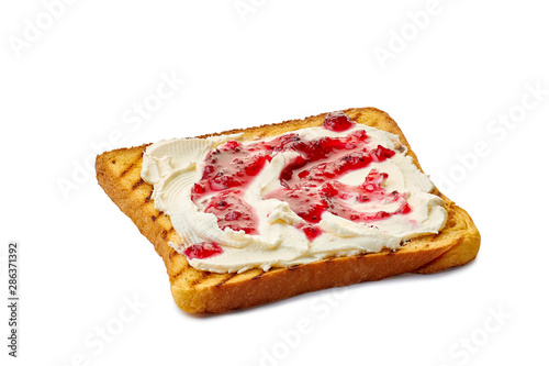 Roasted slice of toast bread with cream cheese and jam on white