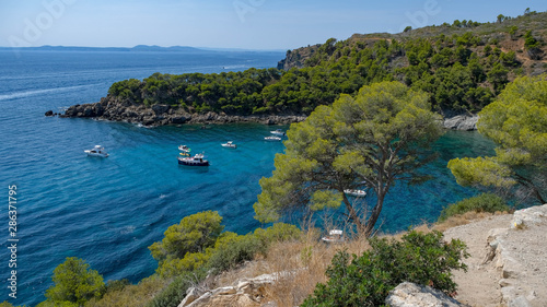Paradisial bays, blue sea, wonderful goldish-sandy beachs with purely water, moorages with boats and yachts. Amazing resort destination. Mediterranean resort in a wonderful bay on a sunny day.