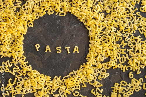 Pasta Alphabet and ingredient for sauce (set of ingredients, raw pasta) serving second course. top food background. copy space