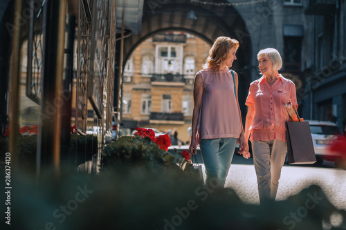 Two women talking while walking stock photo