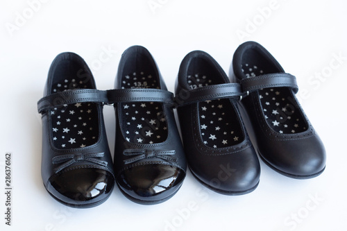 children's classic black new leather school shoes for girls, school uniform isolated on a white background. back to school concept
