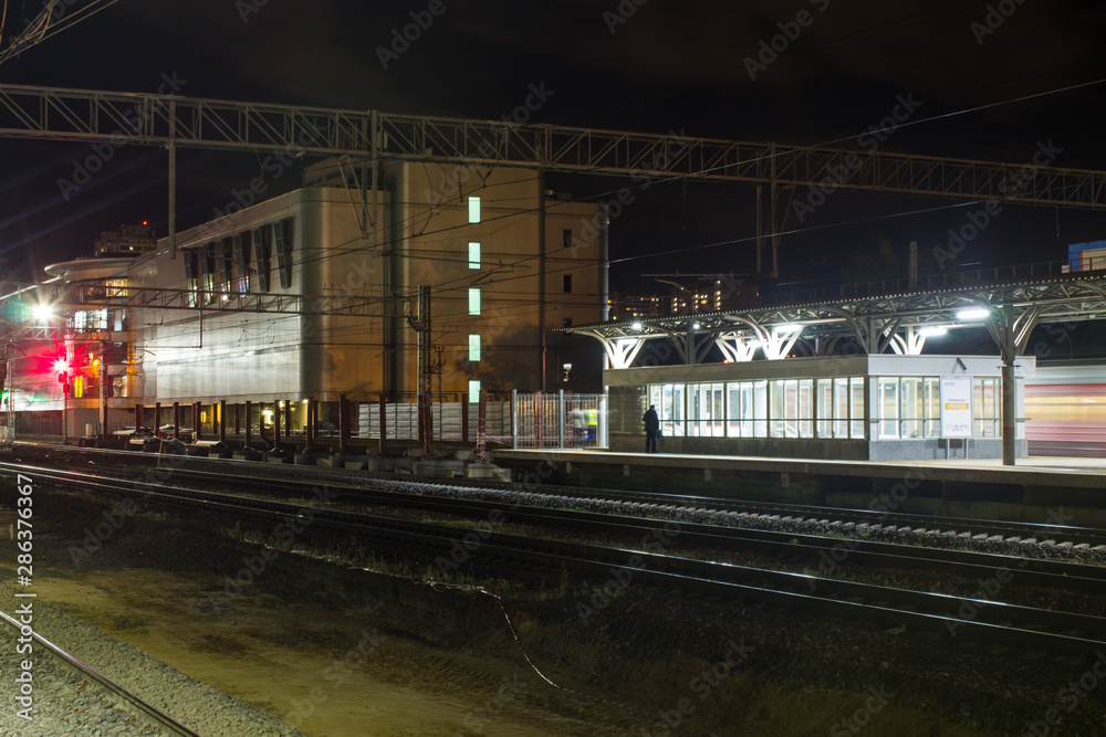 railway station with a train on the tracks late in the evening Moscow Russia