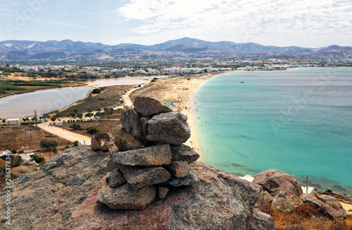 Платно A cairn of stones looking down on Agios Prokopios Beach, Naxos, Greek Islands