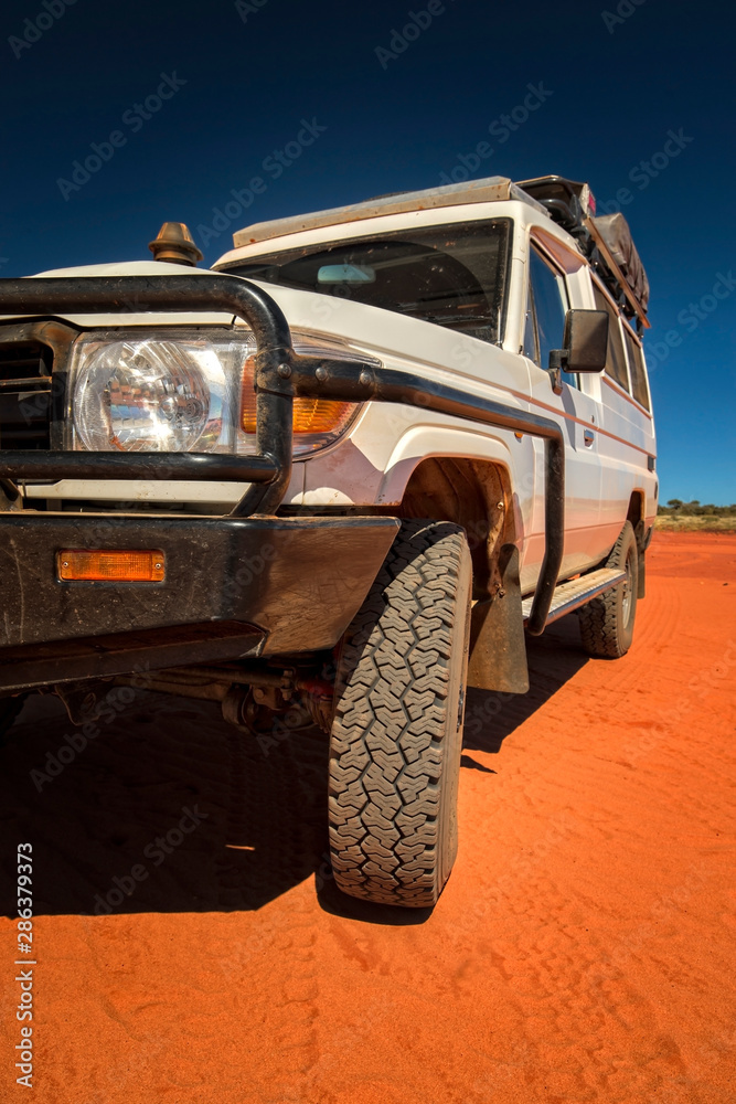 Western Australia – Outback track with 4WD car on red sand at the ocean at Dampier Peninsula Western Australia – Outback track with 4WD car on red sand at the ocean at Dampier Peninsula