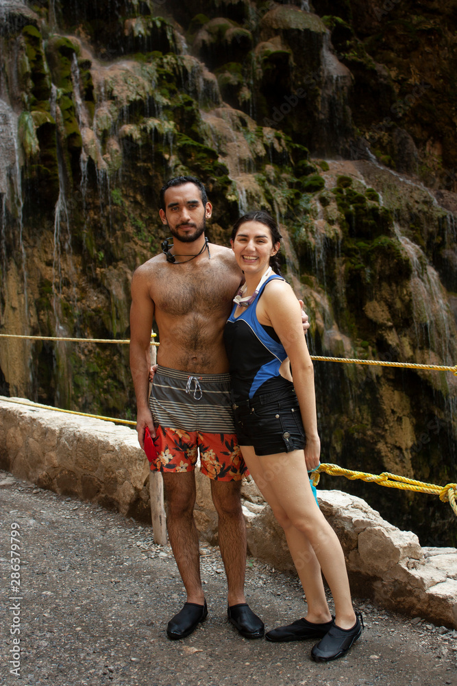 Bodies of a couple in wet swimsuits with drops that run down the skin after a dip in the river Hidalgo Mexico Bodies of a couple in wet swimsuits with drops that run down the skin after a dip in the river Hidalgo Mexico