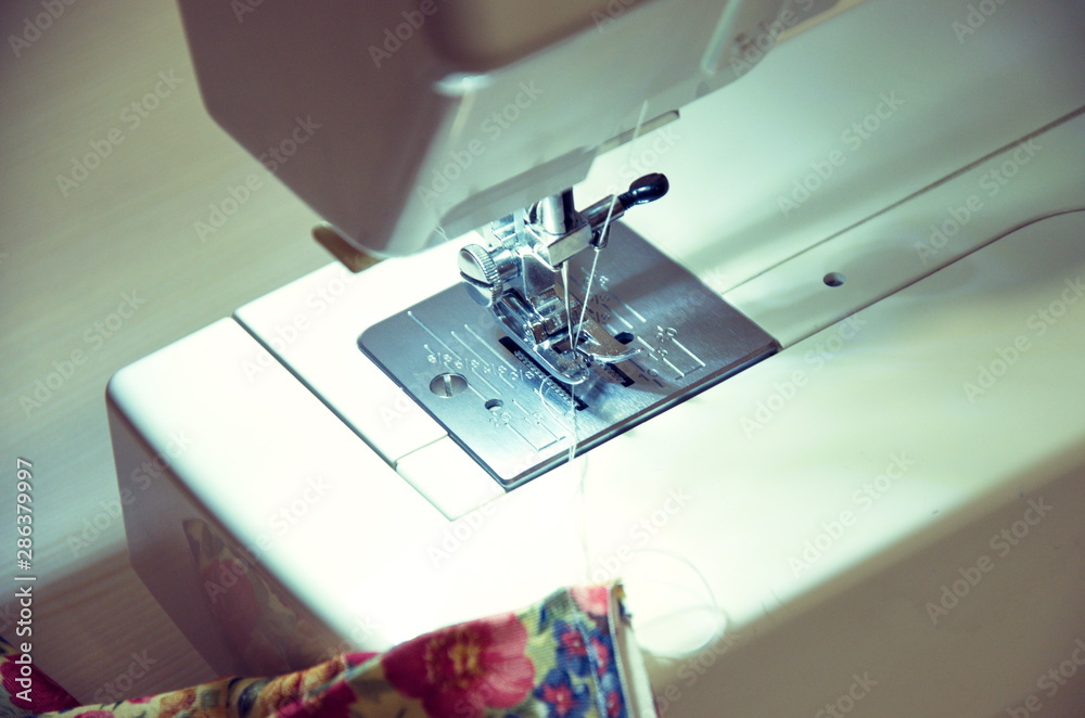 Sewing machine in the process of processing fabric close-up