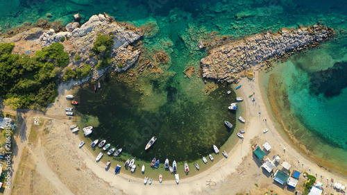 Fototapeta Naklejka Na Ścianę i Meble -  Aerial drone view of iconic sandy turquoise organised with sun beds and umbrellas beach of Paliouri in Kassandra Peninsula, Halkidiki, North Greece