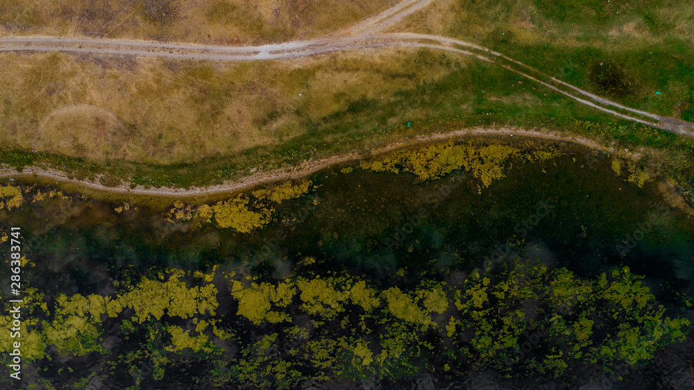 A road in a plain shot from above. A road in a plain shot from above.
