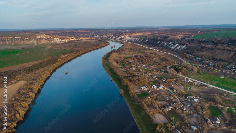 Beautiful shot of a river and a moldavian village to it's right.